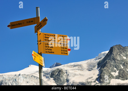 Signpost showing trail directions along mountain path in the Pennine Alps / Walliser Alpen, Valais / Wallis, Switzerland Stock Photo