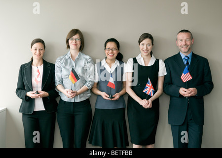 A business group holding flags Stock Photo