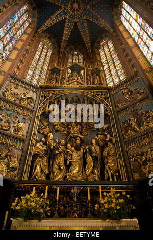 Altarpiece by Veit Stoss in the nave of St Marys Basilica, in front of the East wall apse stained glass windows. Krakow. Poland. Stock Photo