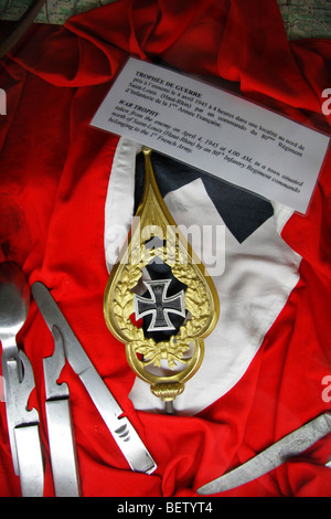 Close up of a German World War One Iron Cross Medal (2nd Class) with setting & Nazi flag.  Airborne Museum, Sainte-Mère-Eglise. Stock Photo