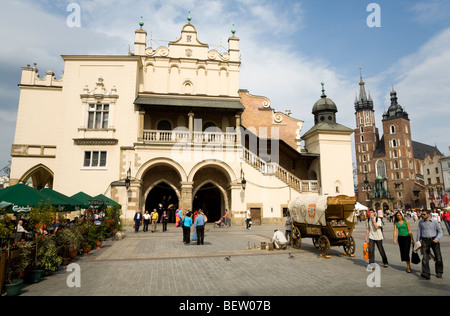 Front of the Sukiennice (Cloth Hall, Drapers' Hall) in main Market Square. Krakow. Poland. St Marys Basilica is to the right. Stock Photo