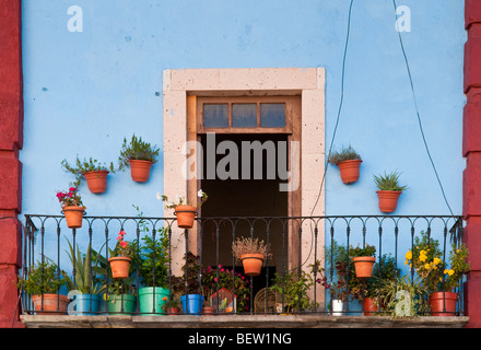 Flower pots on balcony of apartment in downtown Guanajuato, Mexico. Stock Photo