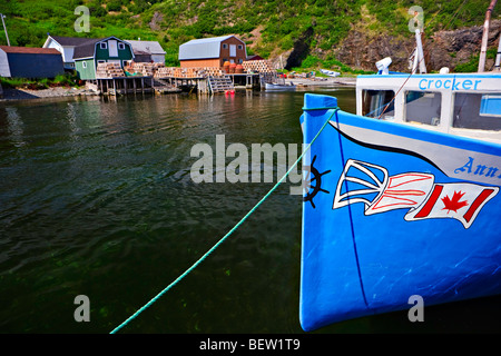 Fishing stages and boats tied up to the dock in the harbour at Trout River, Gros Morne National Park, UNESCO World Heritage Site Stock Photo