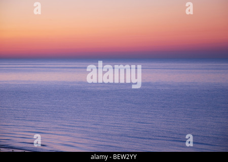 muted colours in early morning sunrise over sea at Eastbourne England United Kingdom Stock Photo