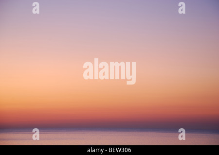 muted colours in early morning sunrise over sea at Eastbourne England United Kingdom Stock Photo