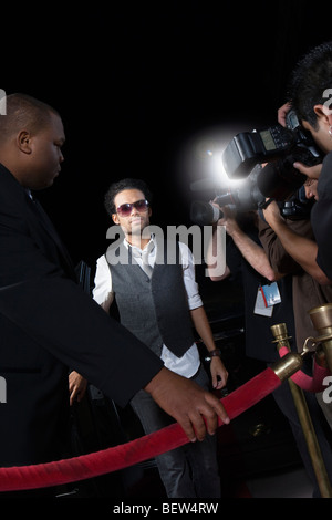 Male celebrity arriving at media event Stock Photo