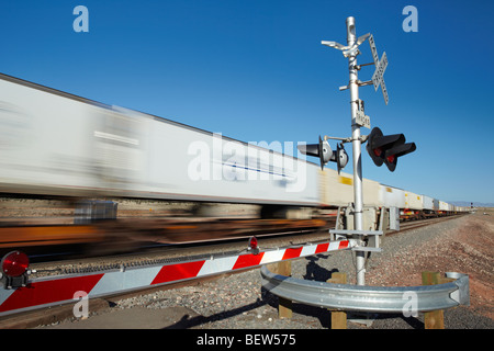 Train passing level crossing, motion blur Stock Photo