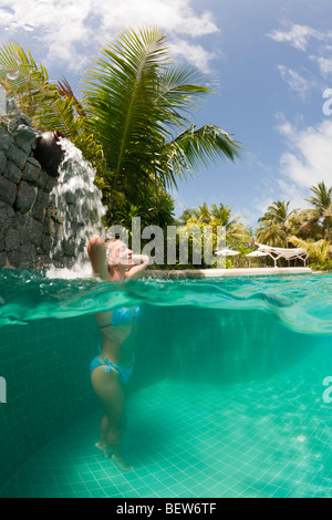 Woman in Swimming Pool, South Male Atoll, Maldives Stock Photo