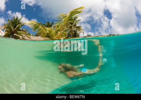 Woman in Swimming Pool, South Male Atoll, Maldives Stock Photo
