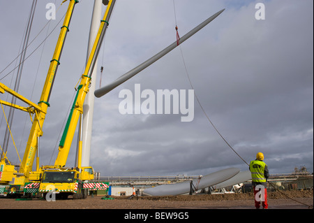Blade being lifted by crane for fitting on Nordex N90 wind turbine under construction at Solutia UK Ltd Newport South Wales UK Stock Photo