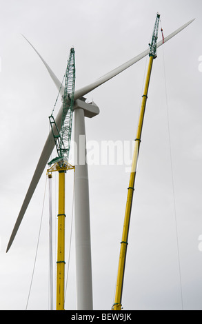 Blades being lifted by crane for fitting on Nordex N90 wind turbine under construction at Solutia UK Ltd Newport South Wales UK Stock Photo