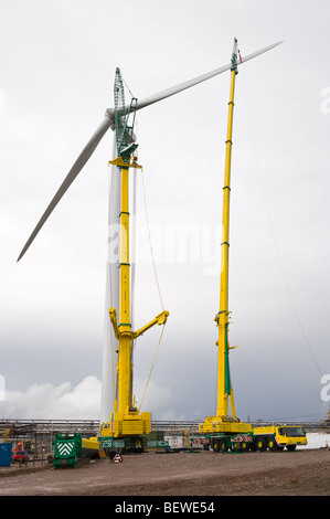 Blades being lifted by crane for fitting on Nordex N90 wind turbine under construction at Solutia UK Ltd Newport South Wales UK Stock Photo