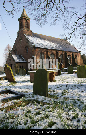 Village of Coddington, England. Winter snowy view of the 19th century St Mary’s Church, located in the village of Coddington. Stock Photo