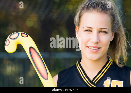 Female hockey player holding a hockey stick Stock Photo