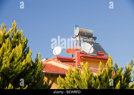 Solar water heaters on houses in Teos, in Western Turkey. Stock Photo