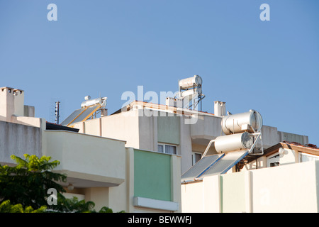 Solar water heaters on house roofs in Teos, Turkey. Stock Photo