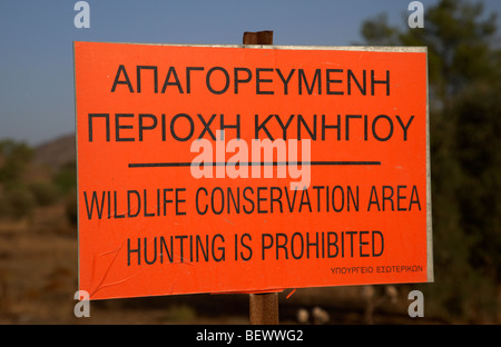 orange warning sign for wildlife conservation area hunting is prohibited in the republic of cyprus europe Stock Photo