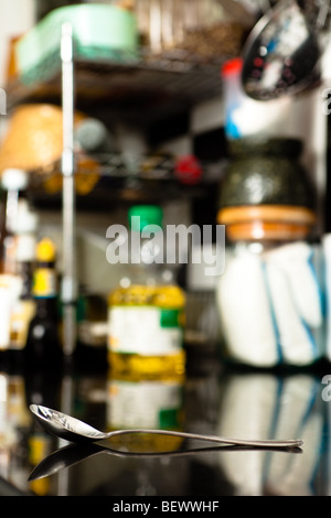 Old and Scratchy Spoon with its reflection isolated by shallow depth of field. Stock Photo