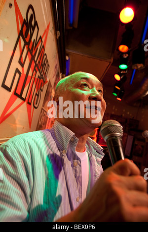 Hide Saito at work in his long established karaoke bar 'Smash Hits', Tokyo, Japan. Stock Photo