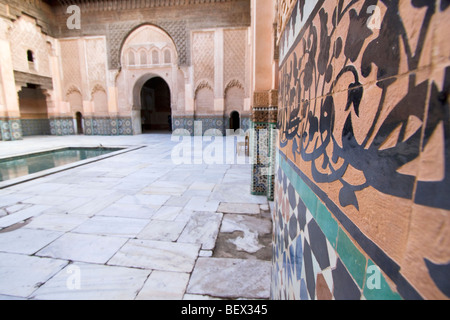 Ornate carved courtyard of the Islamic college Ben Youssef Madrasa named after  amoravid sultan Ali ibn Yusuf. Marrakech Morocco Stock Photo