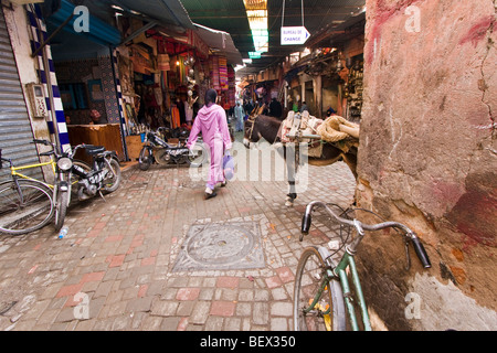 Middle East city. A muslim woman with traditional dress in Souq in Marrakech medina. Marrakech, Morocco Stock Photo