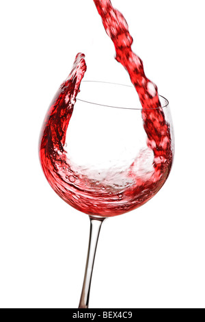 Red wine pouring down from a wine bottle against white background Stock Photo