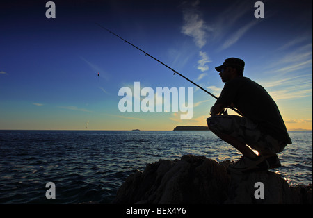 Man fishing on sunset Stock Photo