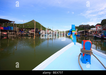 Trip on Thai longtail boat in traditional waterfront village in Central Thailand Stock Photo