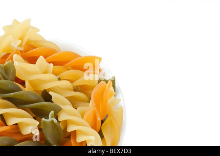 Multicolored pasta with the addition of natural tomatoes and spinach. Top view. Fragment. Stock Photo