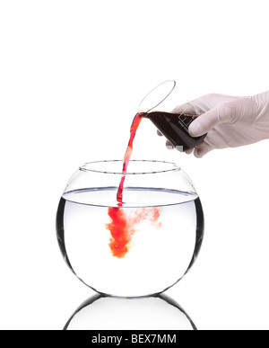 Scientist pouring red liquid into a bowl Stock Photo