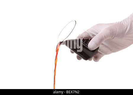 Gloved hand pouring liquid Stock Photo