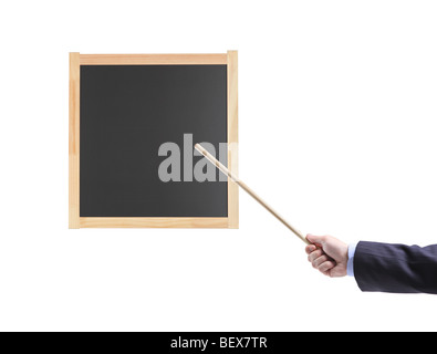 Hand holding a pointing stick on a black school board Stock Photo