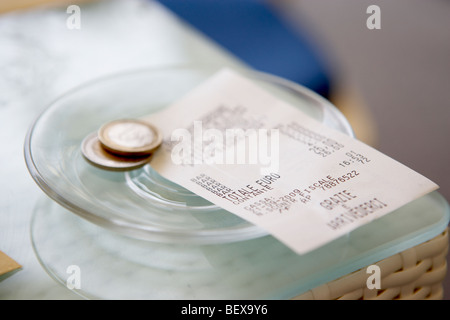 A receipt and two Euro tip Stock Photo