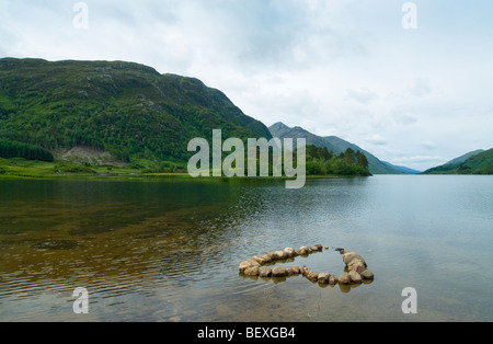 An outline stone heart in the clear waters of Loch Shiel near Glenfinnan, Western Scotland Stock Photo