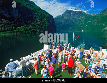 Passengers on deck of car ferry during scenic tour of Geirangerfjord in Norway Stock Photo