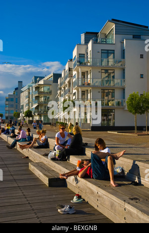 People relaxing at Västra Hämnen the west harbour in Malmö Skåne Sweden Europe Stock Photo