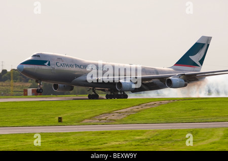 Cathay Pacific Cargo Boeing 747-400 Freighter Airliner B-HUP Touching Down on Runway at Manchester International Airport England Stock Photo