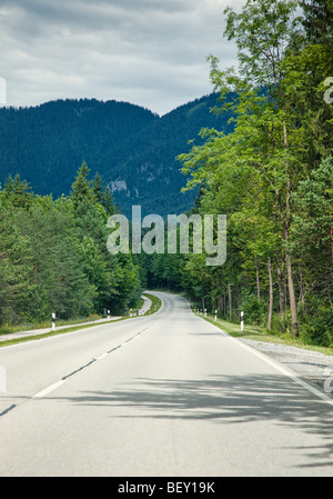 Travelling along an open road through a forest in Bavaria Germany Europe Stock Photo