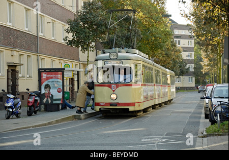 Tram at a tram stop on residential street in Düsseldorf, Germany. Stock Photo