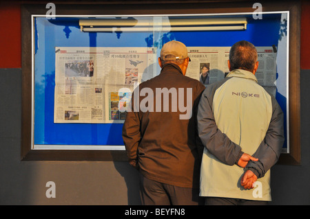 People reading newspapers in Beihai park Beijing China Stock Photo