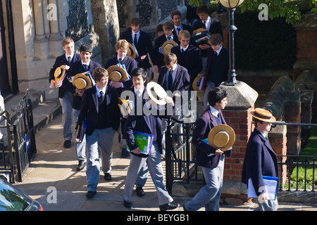 Harrow on the Hill , Harrow School pupils or students in uniform walking in grounds with traditional straw boaters at lunchtime Stock Photo