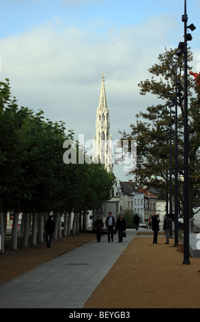 Spire of the Town Hall in the Grand Place seen from a tree lined street in the centre of Brussels Stock Photo