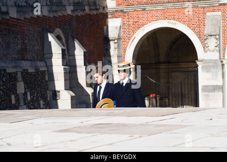 Harrow on the Hill , Harrow School pupils or students in uniform climbing stairs in grounds with traditional straw boaters Stock Photo