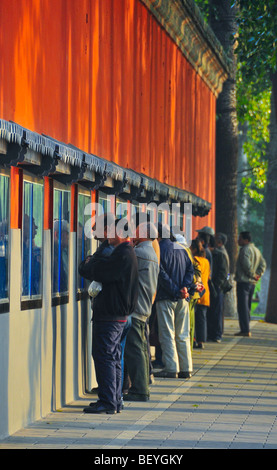 People reading newspapers in Beihai park Beijing China Stock Photo