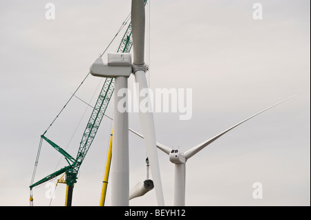 Blades being lifted by cranes for fitting on Nordex N90 wind turbine under construction at Solutia UK Ltd Newport South Wales UK Stock Photo