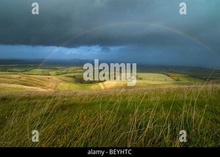 A rainbow over the White Horse vale near Uffington castle hillfort UK Stock Photo