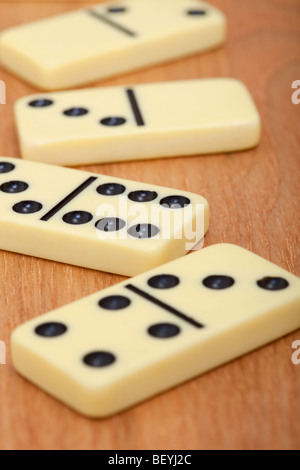 Four bones of dominoes on a wooden background close up Stock Photo