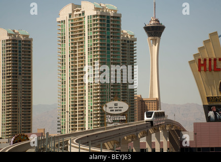 The high level monorail train glides between high rise buildings in Las Vegas, USA.