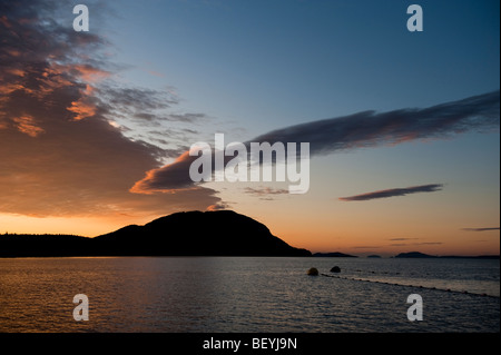 Fishing buoy lines and head cans from a Salmon reefnet gear appear to extend out to Lummi Mountain in the San Juan Islands. Stock Photo