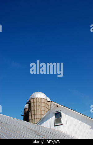 White barn under blue skies Stock Photo